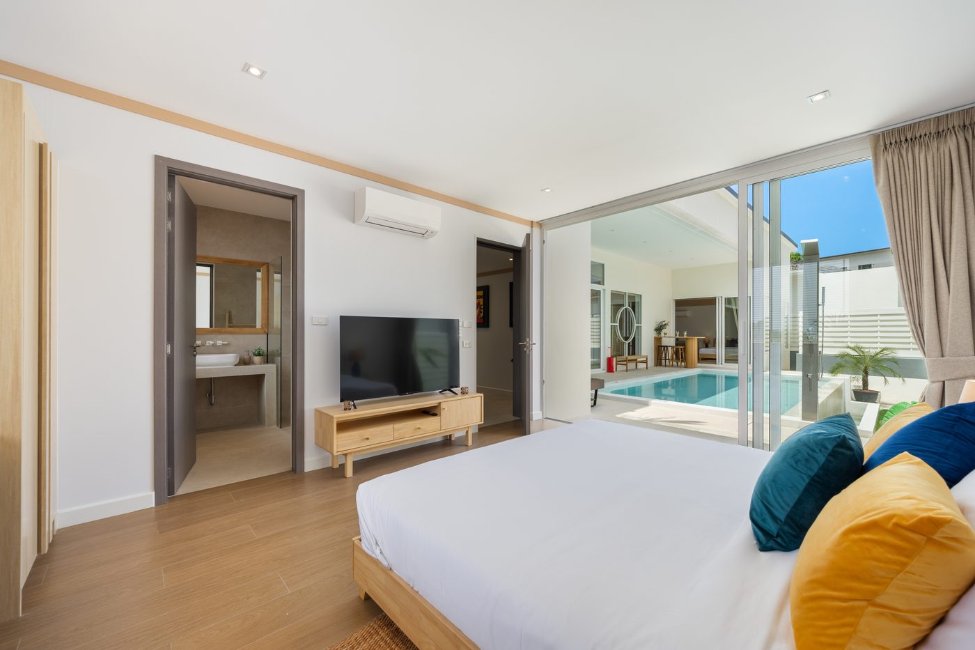 Bedroom with en-suite bathroom and sliding doors to the private pool